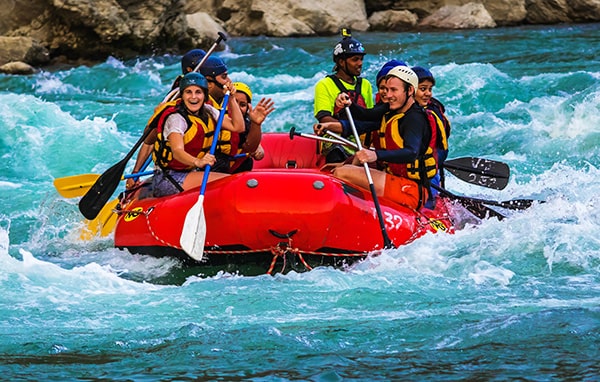 Smiling team on a rafting trip